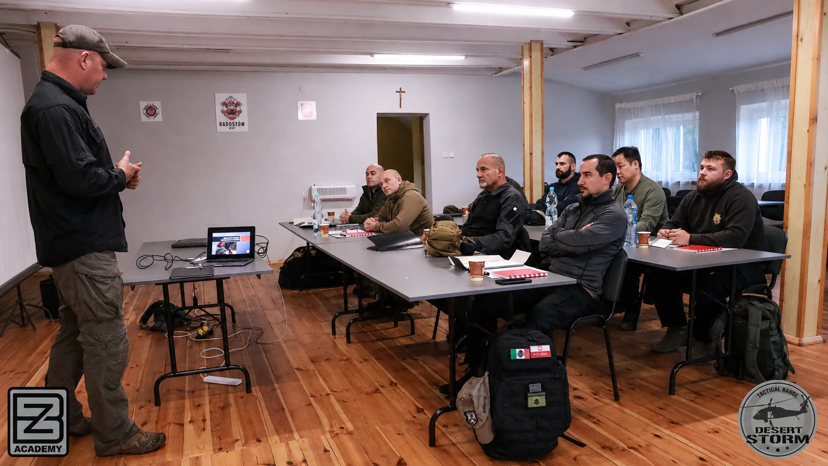 BZ Academy instructor coaching a pistol shooter during instructor-level training in Poland