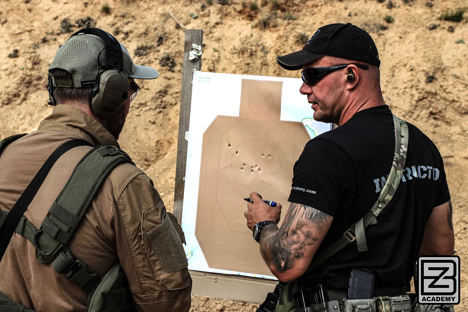 BZ Academy instructor reviewing CFC Level 1 shooting results on target in Poland