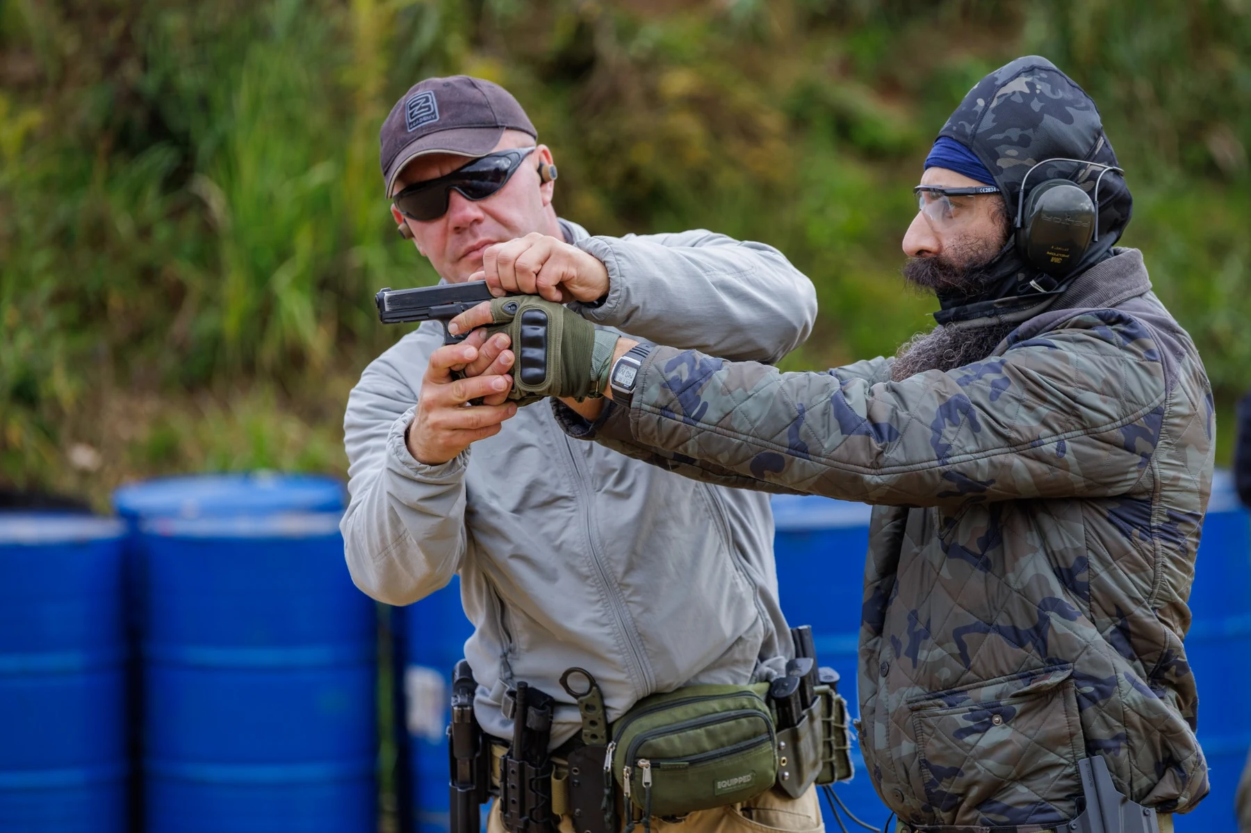Close instructor coaching during pistol training at BZ Academy in Poland