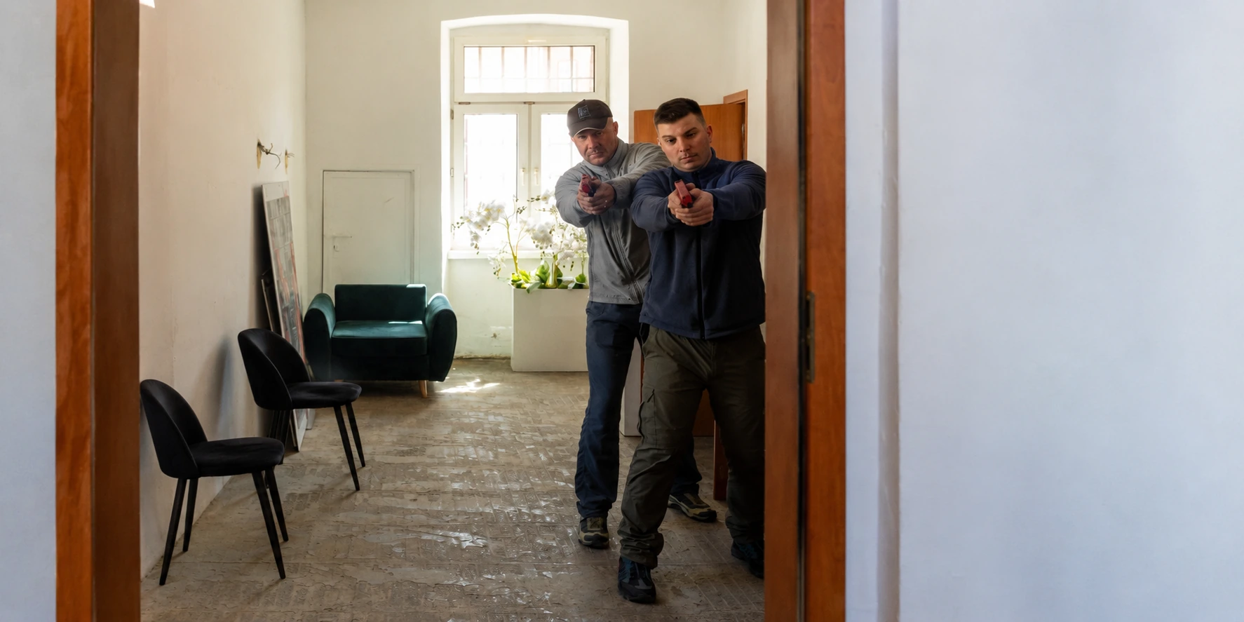 Two Man CQB pair advancing through a corridor while maintaining formation at BZ Academy in Poland